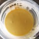 In a medium bowl, add some flour, salt, turmeric powder, and some water. Mix until it forms a smooth batter.