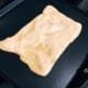 Flatten the ball and make a square or circle shape and grill roti canai over a skillet or a pan.