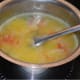 Step two: Take the moong dal mixture in a vessel. Add 4 cups of water, lemon juice and salt. Boil it for 3 minutes. Turn off the heat.