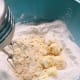 Combine the butter into the dry mixture. Beat them together with a mixer at medium speed.
