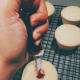 Fill each cupcake with the strawberry preserves.
