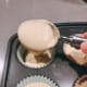 Use an ice-cream scoop to fill each cupcakes cup.