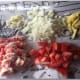 Prep your ingredients: bacon, tomatoes, onions, garlic, and ginger root.