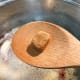 Add the chicken bouillon cube into the pot and stir until it's dissolved.