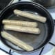 vegan sausages are put on to fry in a little oil