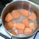 Chopped sweet potatoes ready for boiling