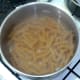 Simmering wholewheat fusilli pasta