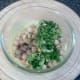 Chickpeas and coriander are added to yoghurt sauce