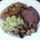 Steak and accompaniments are arranged on serving plate