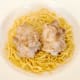 Chicken thighs are sat atop egg noodles