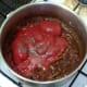 Tomatoes and seasoning are added to onion and spices