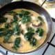 Egg is poured over spinach and mushrooms