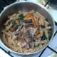 Kipper flakes and black pepper are added to pasta and spinach