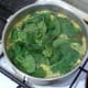 baby spinach leaves are added to simmering rice for the final two minutes of cooking