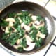 Spinach is arranged around sauteed mushroom slices