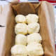 Divide the dough into equal-sized balls and transfer to the prepared pan.