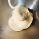 Mix at the low speed for about 5 minutes until the dough comes together to form a ball.