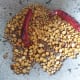 Roast until the chana dal turns golden and the coriander and cumin seeds begin to crackle. Switch off the flame and set aside to cool.