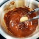 Dip the cookie into the melted chocolate.