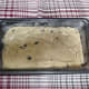 Pour the batter into a greased loaf pan and place it in the oven at 350 degrees F.
