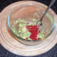 Guacamole ingredients are combined in a bowl