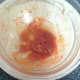 Sardines are removed from bowl leaving tomato sauce