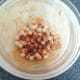 Chickpeas are seasoned and stirred in to tomato sauce