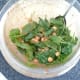 Spinach is stirred in to chickpeas in tomato sauce