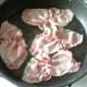 Bacon is fried in a little oil