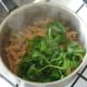 Baby spinach leaves are added to steaming hot pasta