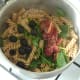 Sun dried tomatoes and black olives are added to pasta