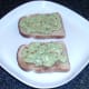 Guacamole is spread on toast