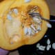 Scoop out the pulpy strands and seeds (save the seeds for a baked snack). I find using a metal spoon to scrape the insides helps remove a lot of the stringy pieces.