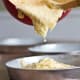 Adding the cake batter to your cake pans.