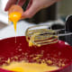 Adding eggs into your cake batter.