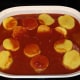 Pour diluted tomatoes over meat and potatoes. Ready for the oven!