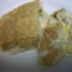Classic chicken pot pie, family style, with potatoes, corn, carrots, and peas.