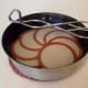Gently simmer the lids (don't boil!), or set them in a cake tin and pour on boiling water to cover, to scald them.