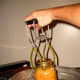 Lift each jar out carefully with a jar lifter. If you have waited for the canner to cool sufficiently, you should be able to remove the jars promptly.