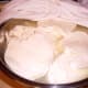 These slices were placed in a dry dish containing no water or way. 24 hours later, they had exuded enough whey to almost cover them. The salt helps them dry out properly.