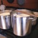 Warming 8 gallons of raw goat's milk to 86 degrees F., before adding yogurt.