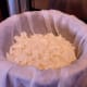 This is about how many curds you should have in each towel. These are ready to be tied up in a bag to finish draining.