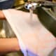 Let the water flush out any large cheese particles.