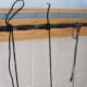 You may have to modify your tying style according to the lengths of your strings. It is best if you can loop it around three times and pull the tail partly through the last loop for a "quick release" type knot..