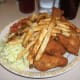 Coleslaw with fried chicken and French fries.