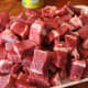 You want your beef brisket to be trimmed of its fat and cut into cubes like in the photo here.