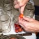 Prick each plum with a pin, needle, or knife, so it doesn't explode when heated. Pack plums snugly into jars.