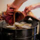 Carefully place rack of filled jars into a canner of simmering water. Beware of splashes and steam burns! Put on lid.