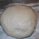 Once your bread has risen, punch it down, form it into a ball, and pop it onto a baking sheet.
