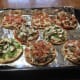 Mini Pizzas made on round flatbreads, ready for oven